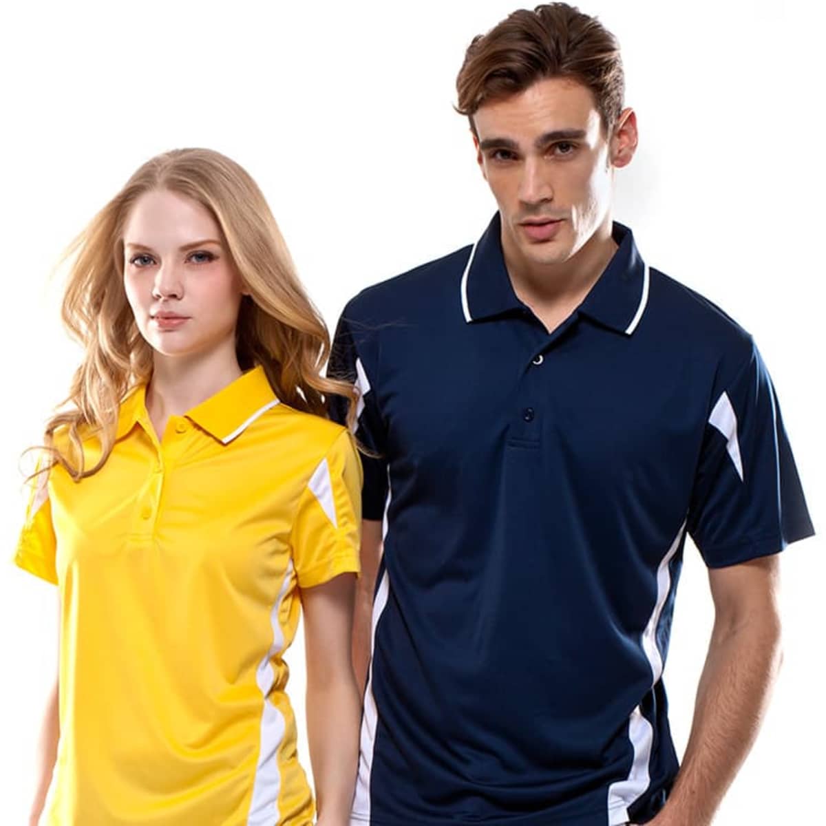 A yellow and navy polo shirt featuring white accents, worn by a male and female model. The image includes branding.
