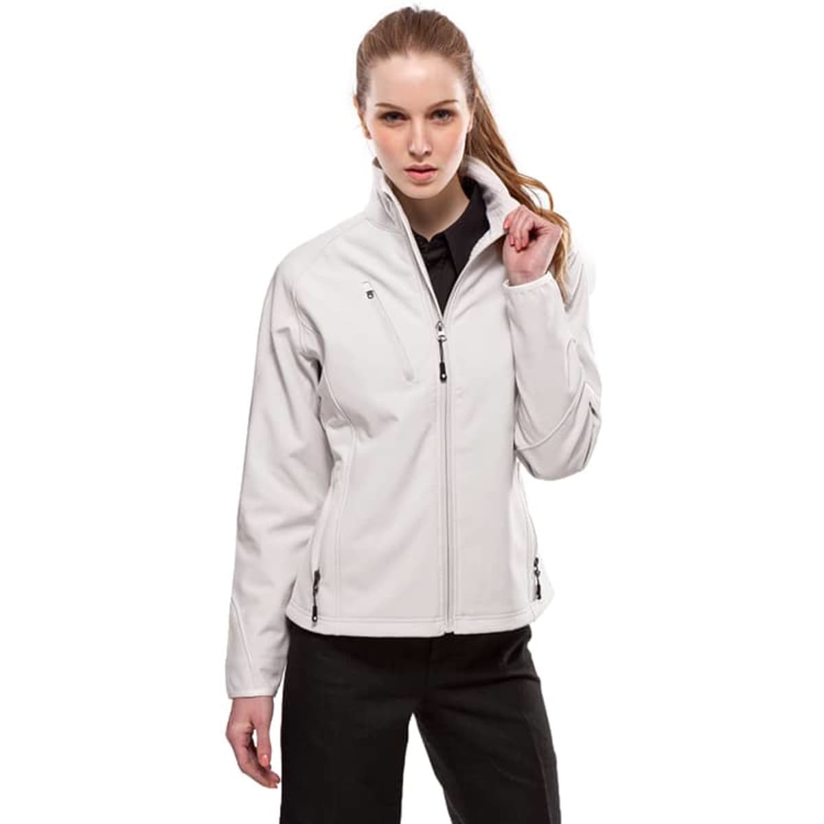 A woman is wearing a light grey Vista Jacket. The jacket features a high collar and zippered pockets.