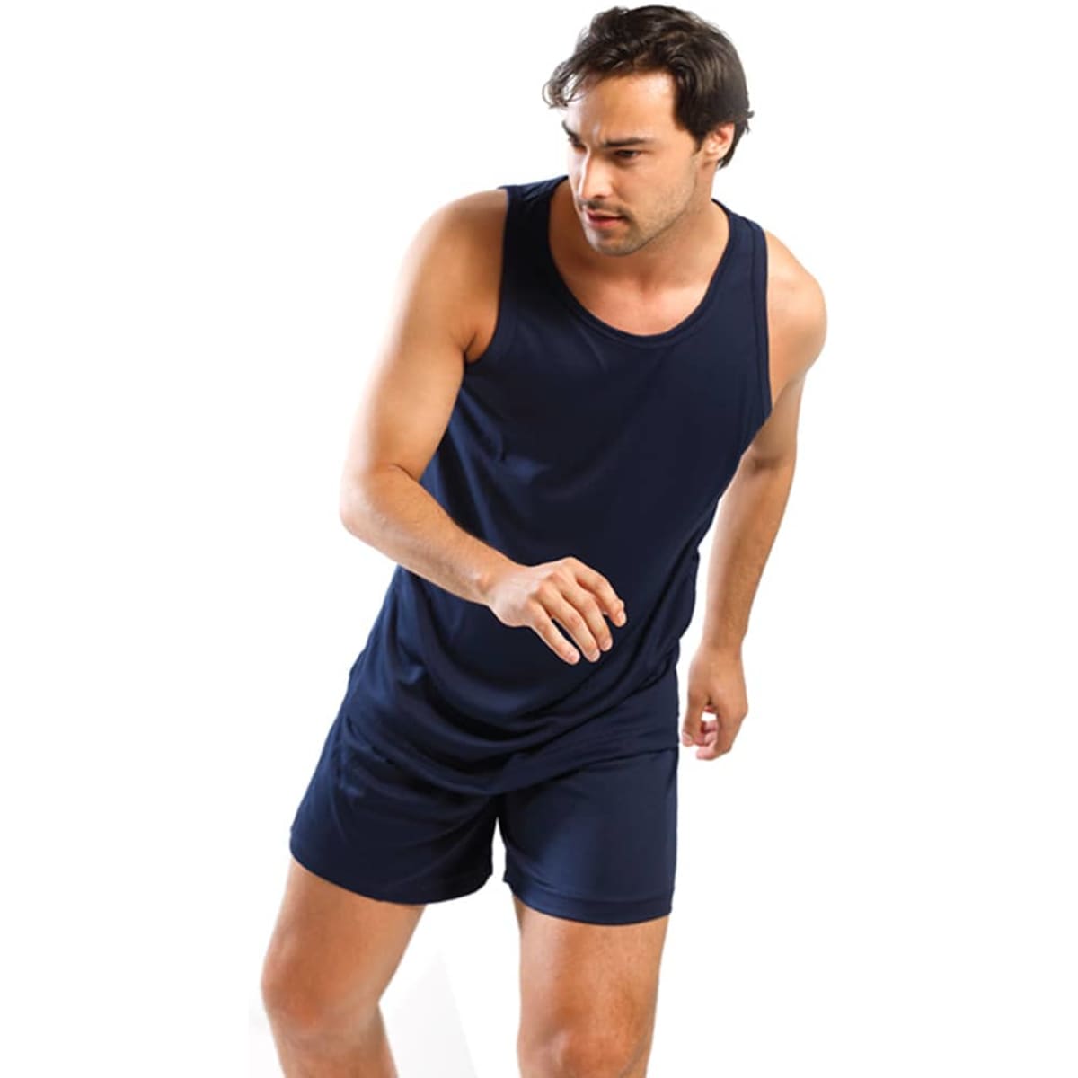 A man wearing navy blue sports shorts and a matching tank top, featuring a logo on the shorts.