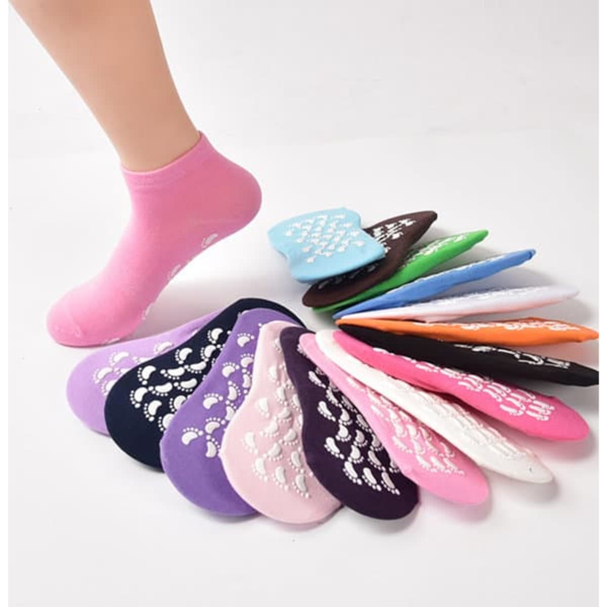 Non-slip yoga socks in various colours including purple, pink, blue, green, and black, with grip patterns on the soles.