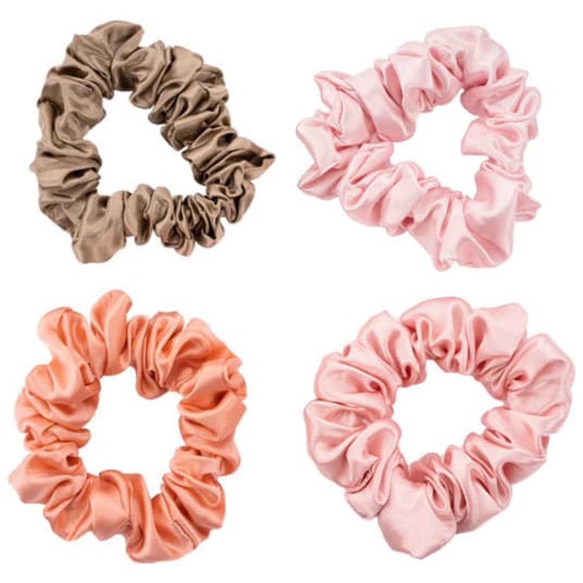 A set of silk hair ties in brown, pink, and peach hues, displayed in a decorative arrangement. Each tie features a scrunched design.