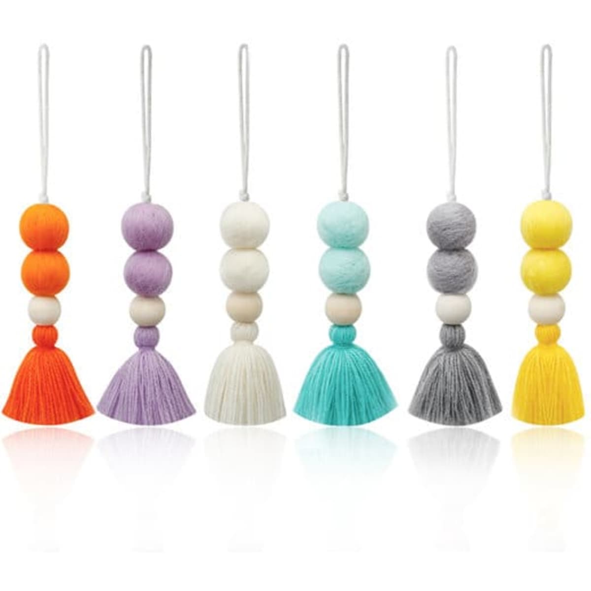 A collection of six decorative air freshener pendants in various colours including orange, purple, white, teal, grey, and yellow.