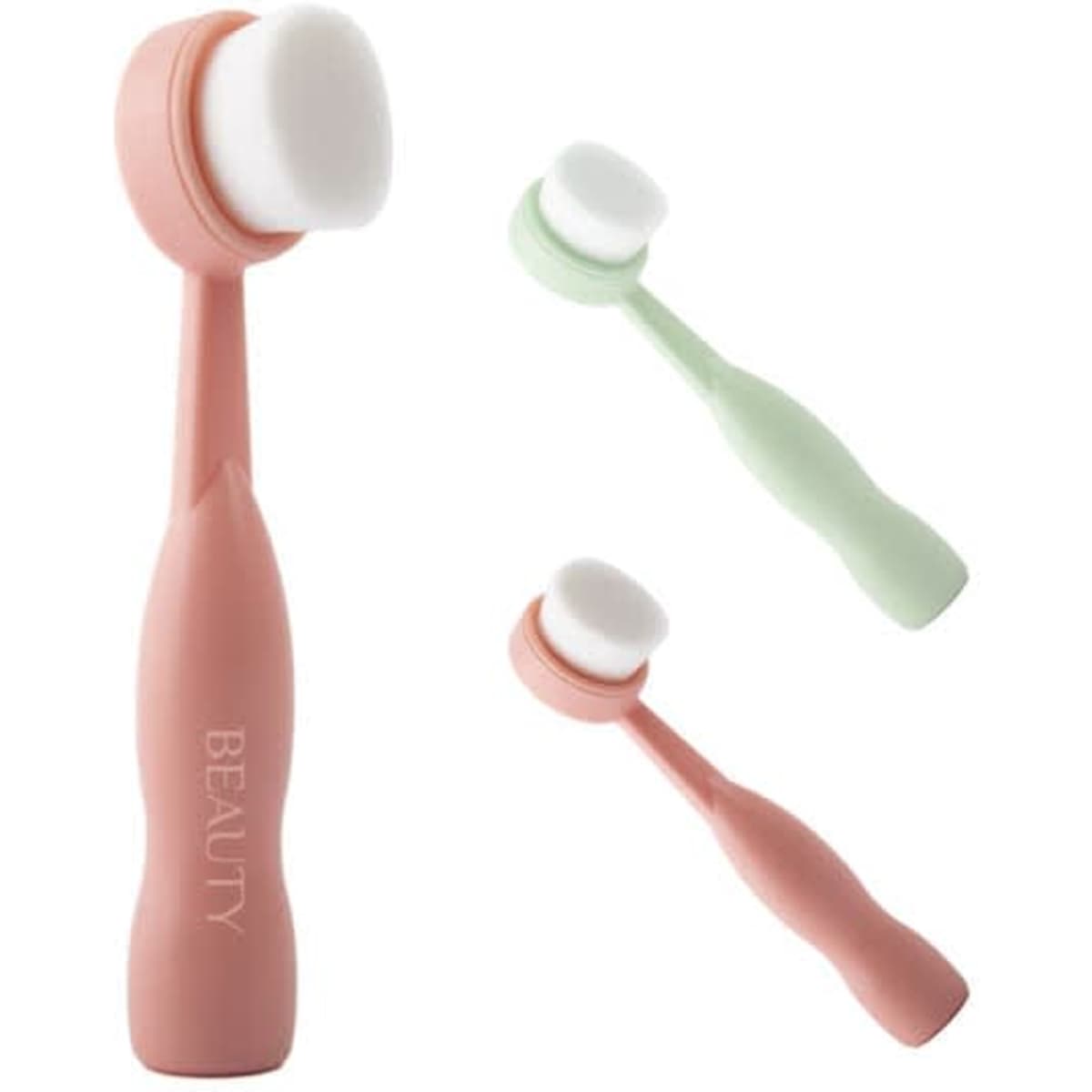Three soft facial cleansing brushes in pink and green, featuring a smooth, round brush head and ergonomic handles. Each has a logo.