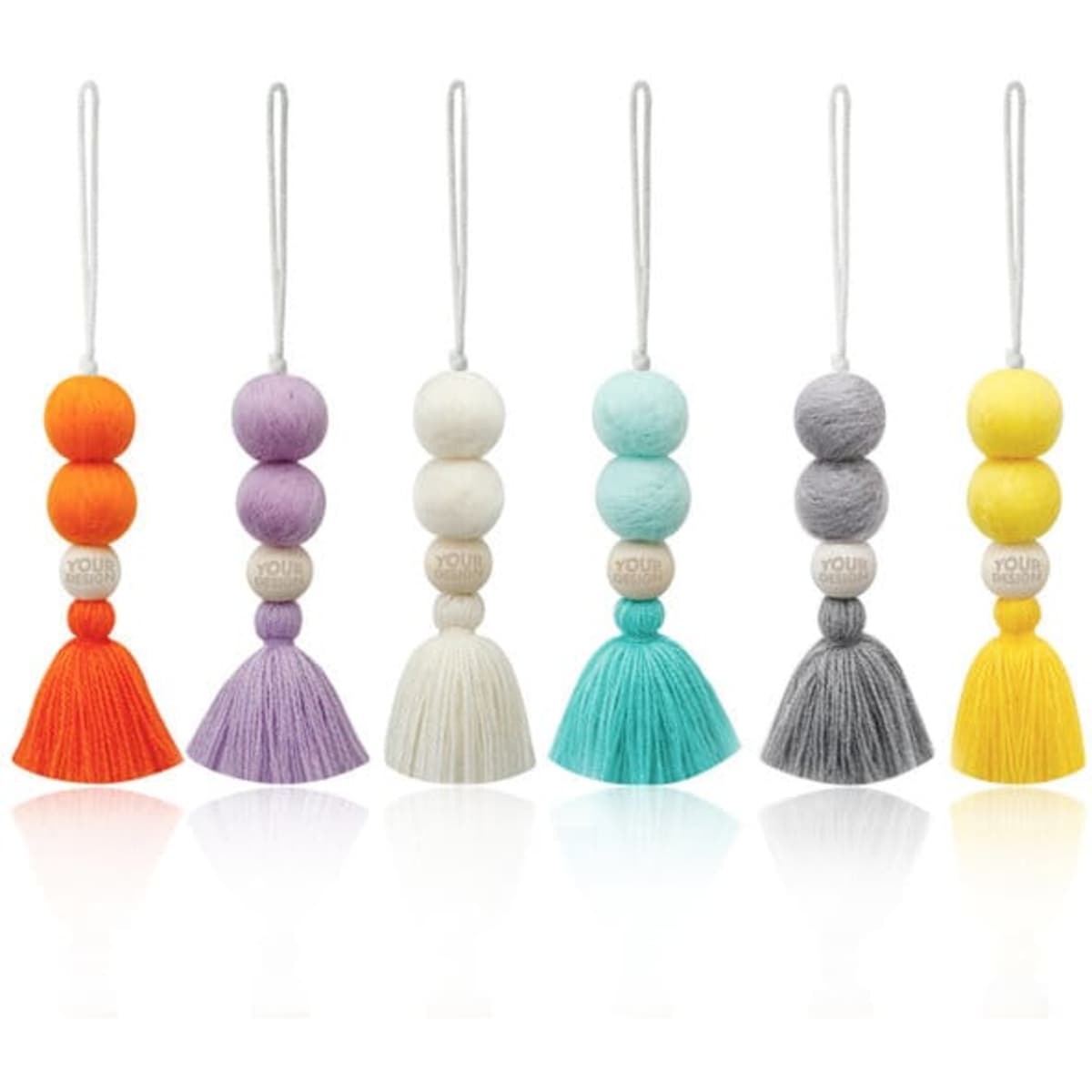 A collection of car essential oil tassel diffusers in various colours, featuring felt balls and tassels.
