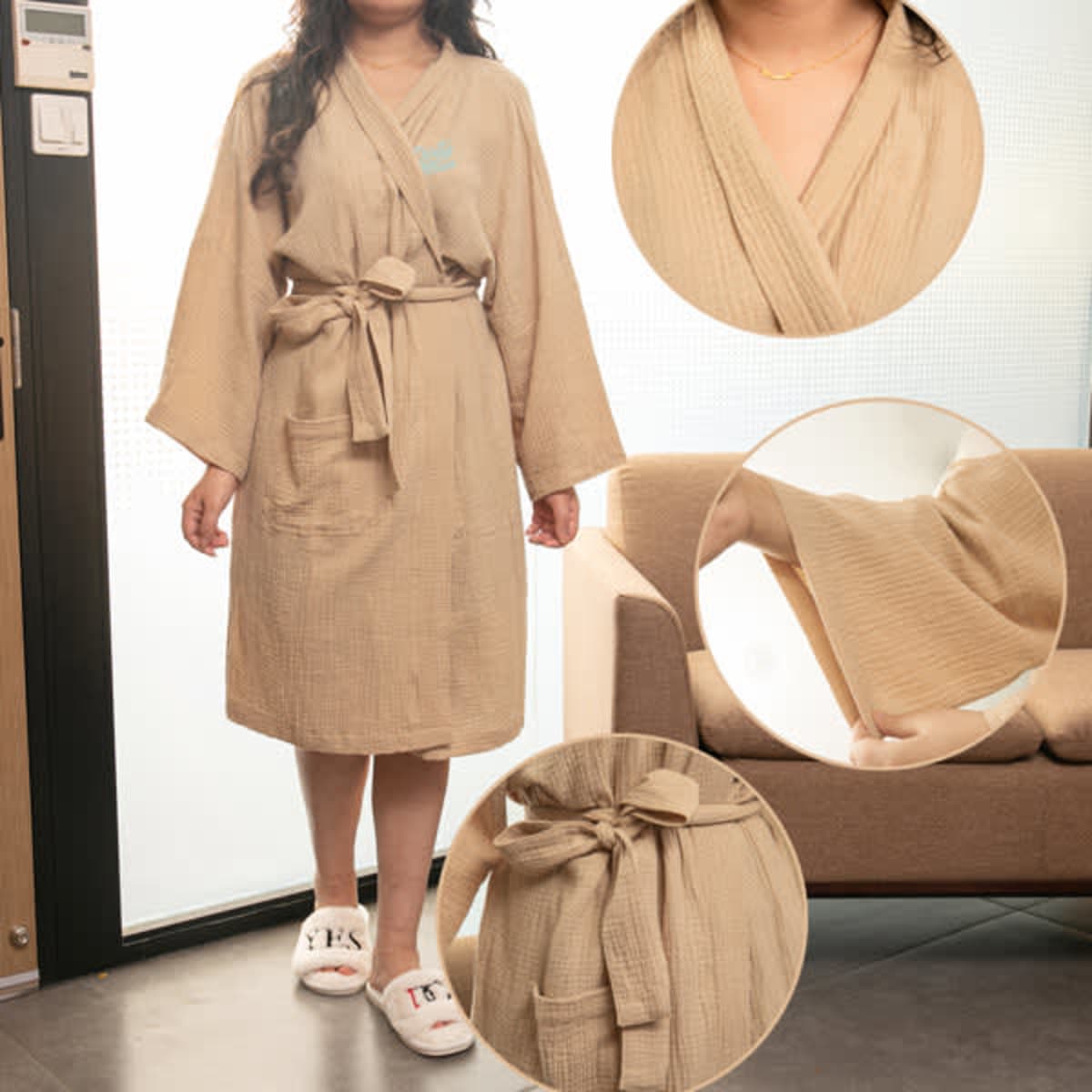 A long cotton bathrobe in a soft beige colour, featuring a belt and pockets, displayed on a model.