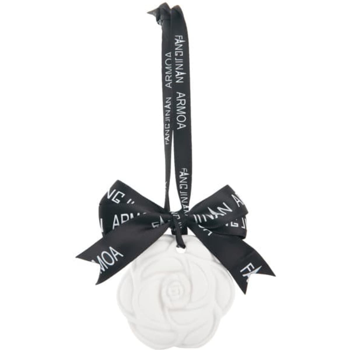 A white hanging gypsum aromatherapy tablet in the shape of a flower, secured with a black ribbon and bow.