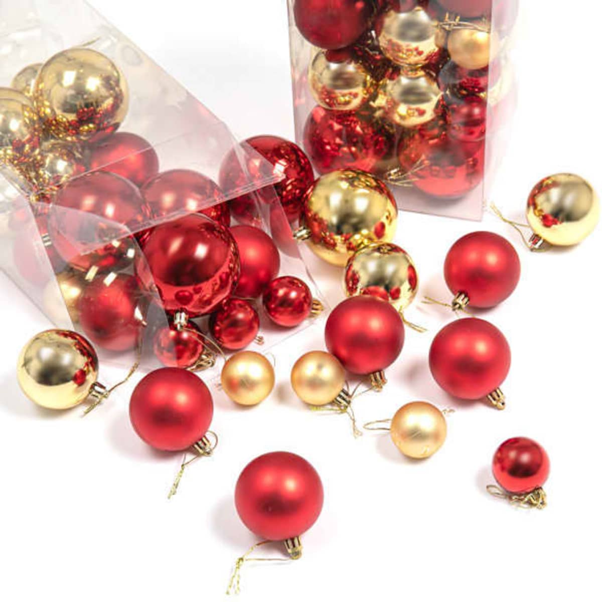 A collection of red and gold Christmas ornament balls in transparent packaging, featuring various sizes and glossy finishes.