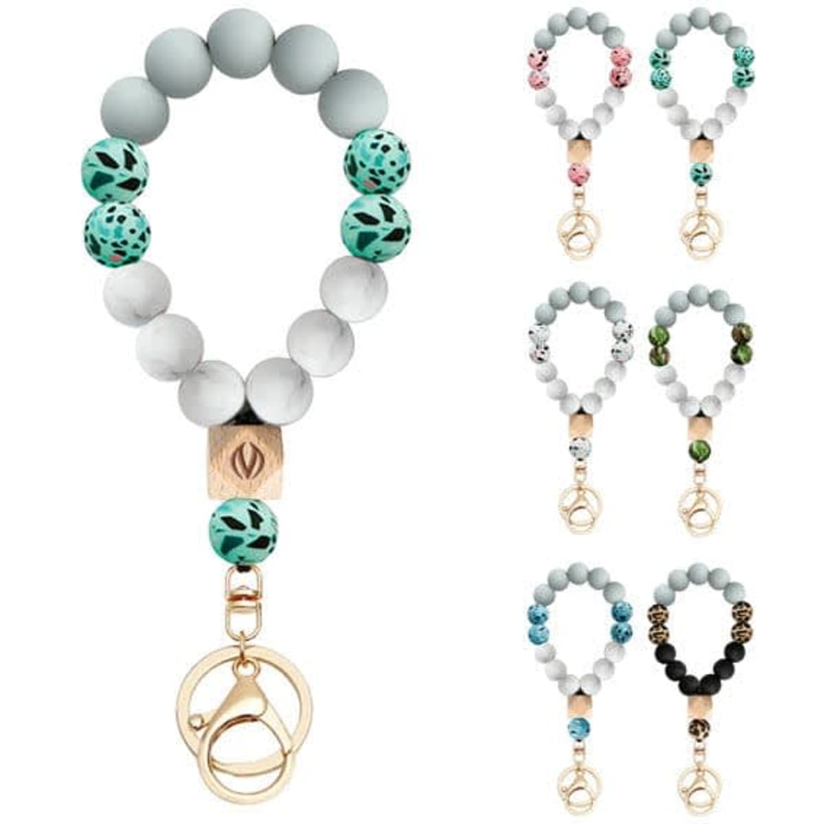 Beaded silicone bracelets in various colours with a keychain attachment. Features decorative beads and a logo.