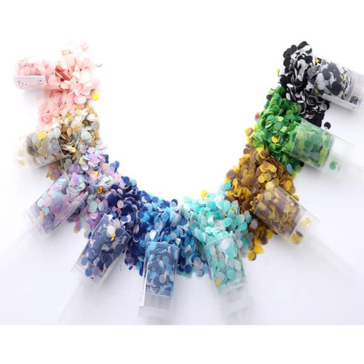 A variety of rectangular containers filled with multi-coloured confetti, including pink, blue, green, and black.