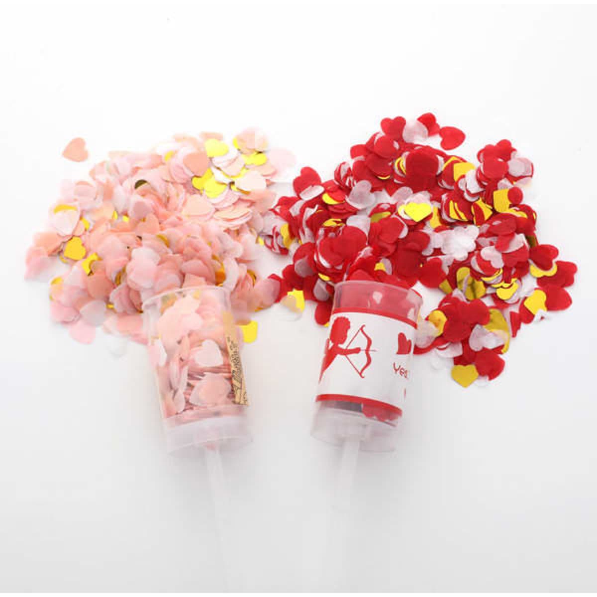 Confetti poppers in pink and red, filled with heart-shaped confetti for celebrations. Each popper has a logo.