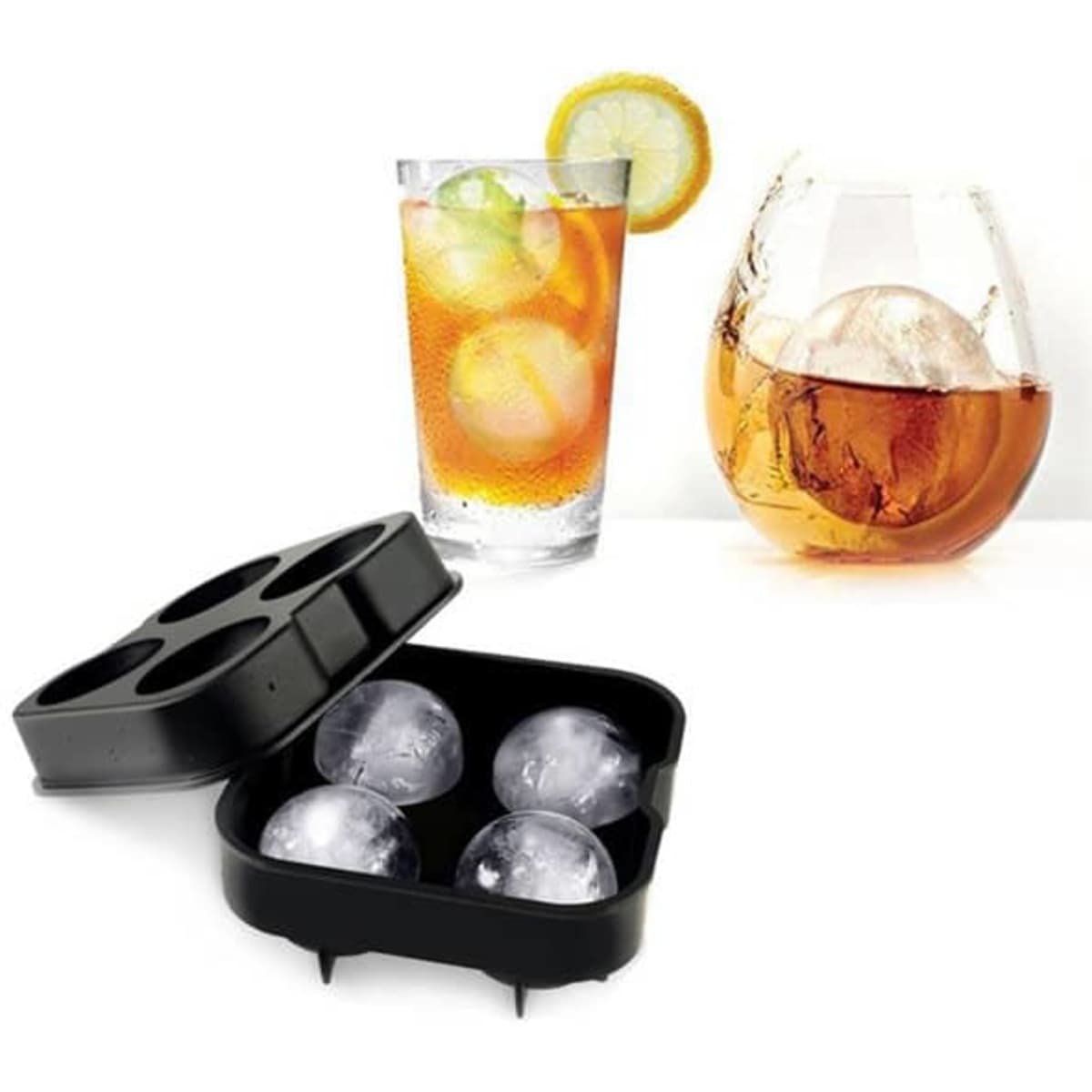 A black silicone ice cube tray with four compartments, next to two glasses of drinks featuring large ice cubes.
