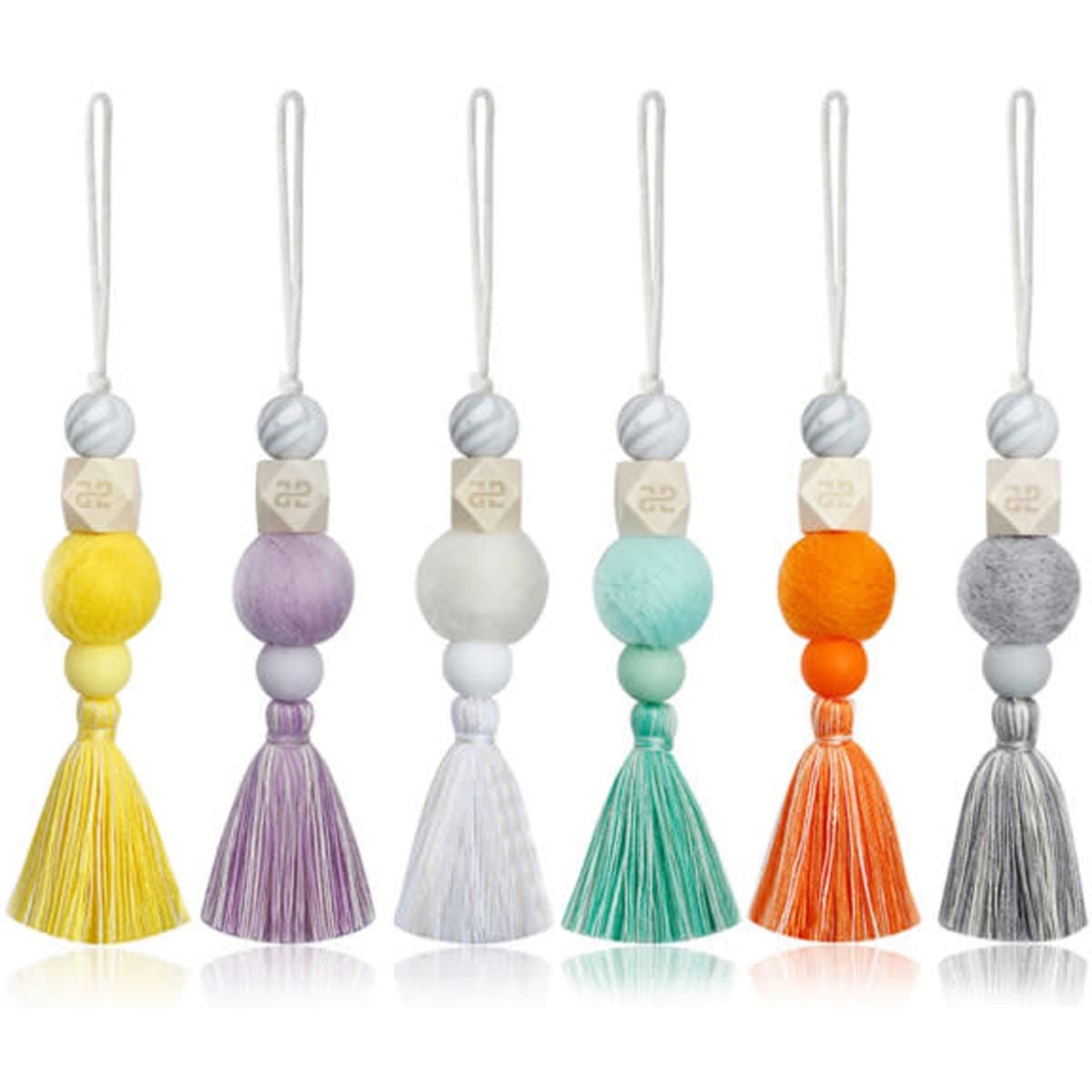 A collection of six felt ball diffuser pendants in various vibrant colours, featuring tassels and wooden beads.