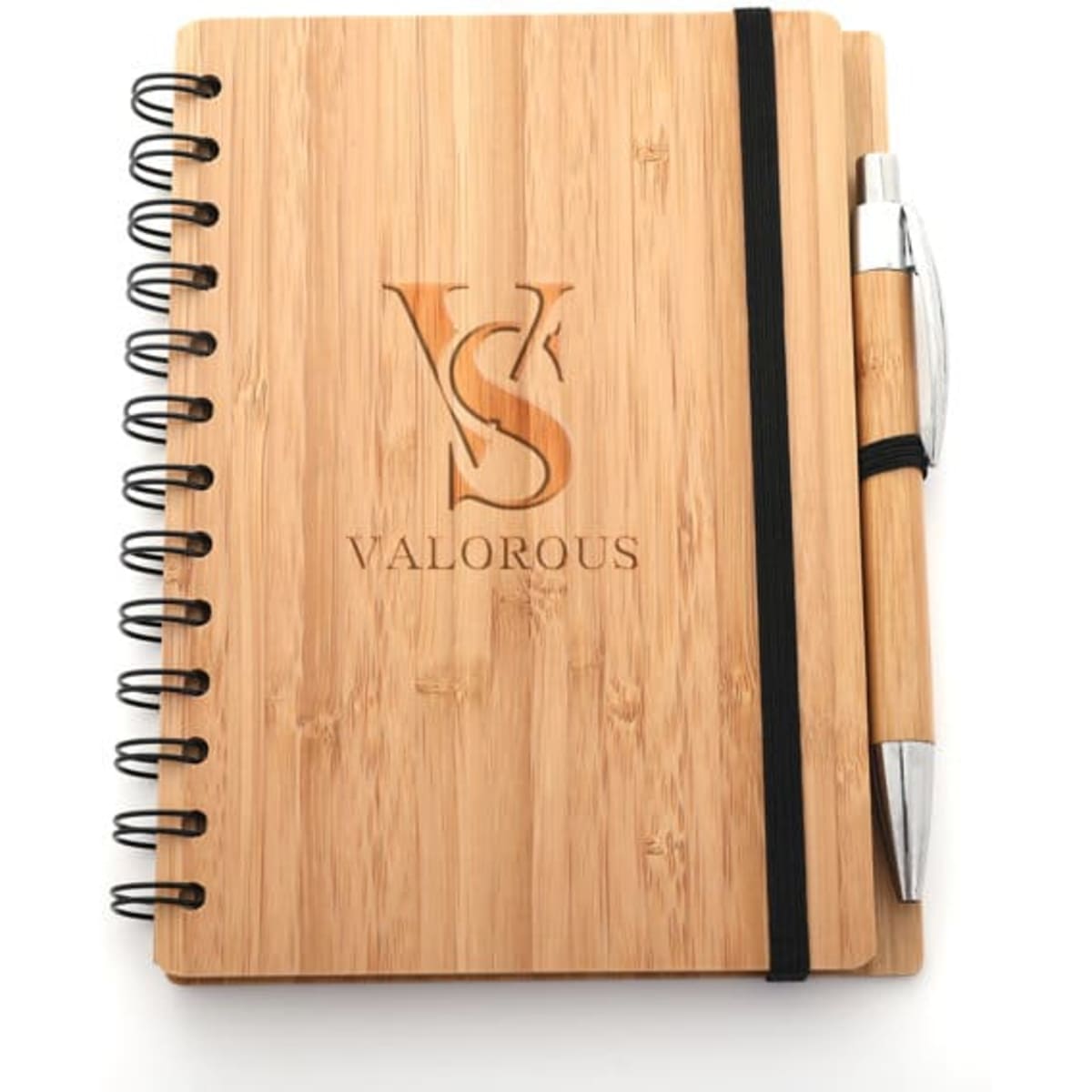 A bamboo spiral notebook with a black elastic band and a silver ballpoint pen attached. It features a logo on the cover.