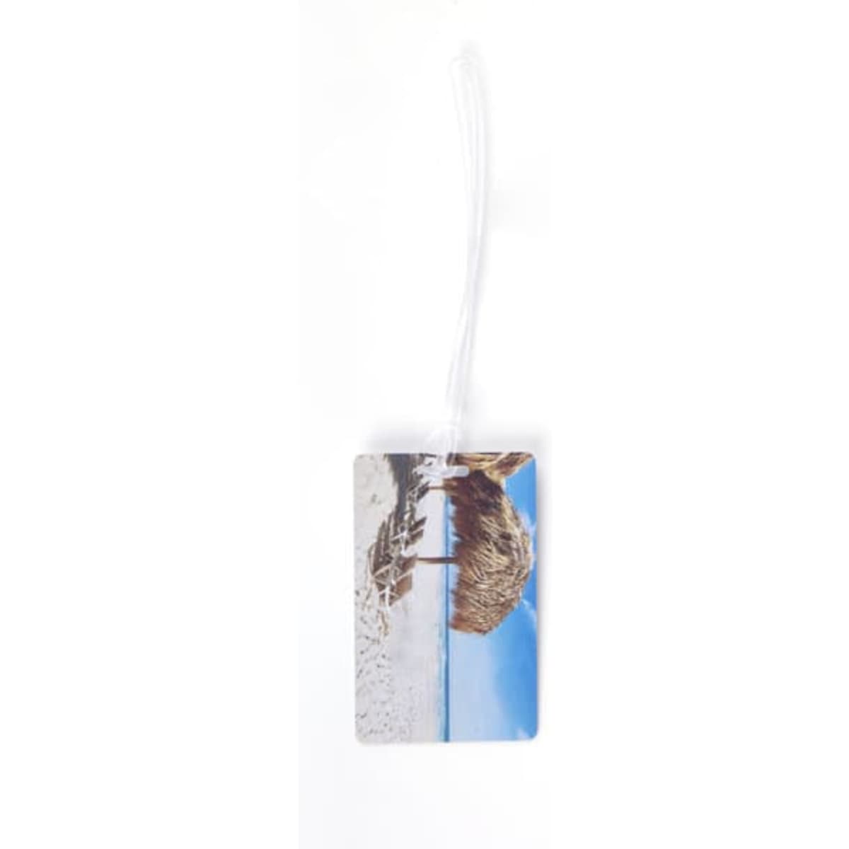 A PVC luggage tag with a loop featuring a beach scene and bright blue sky. It includes a logo.