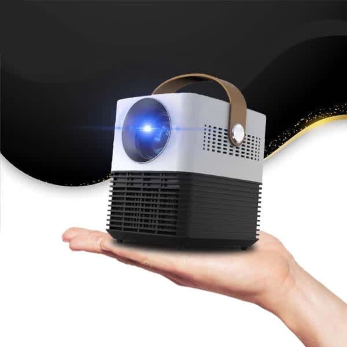 A compact mini projector with a handle, featuring a silver and black design, held in a person's hand.