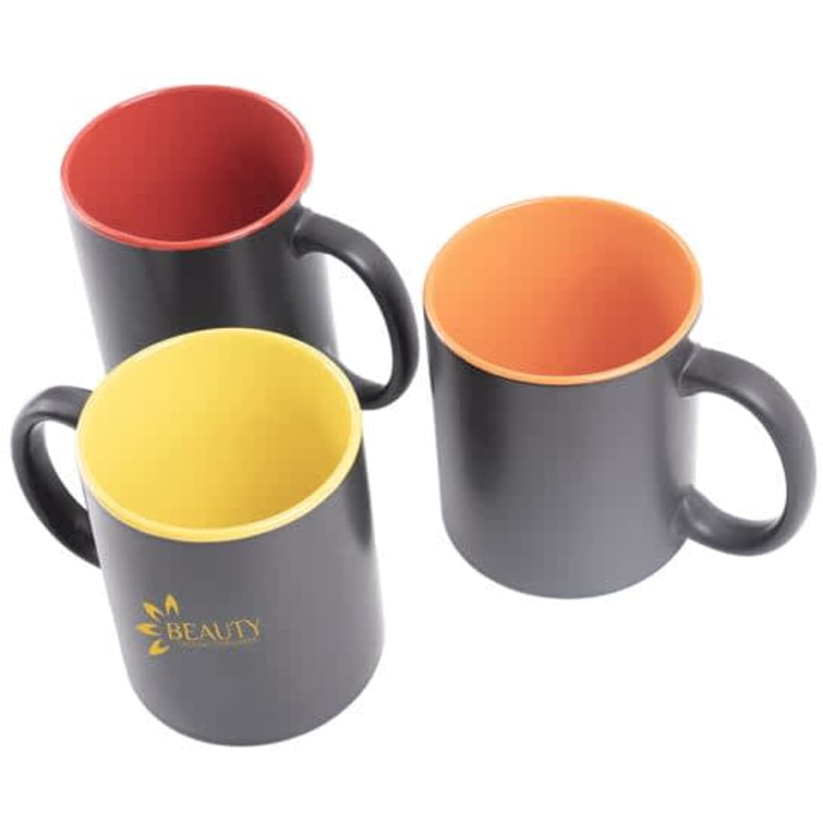 Three ceramic coffee mugs with black exteriors and vibrant coloured interiors in red, yellow, and orange. Each has a handle.