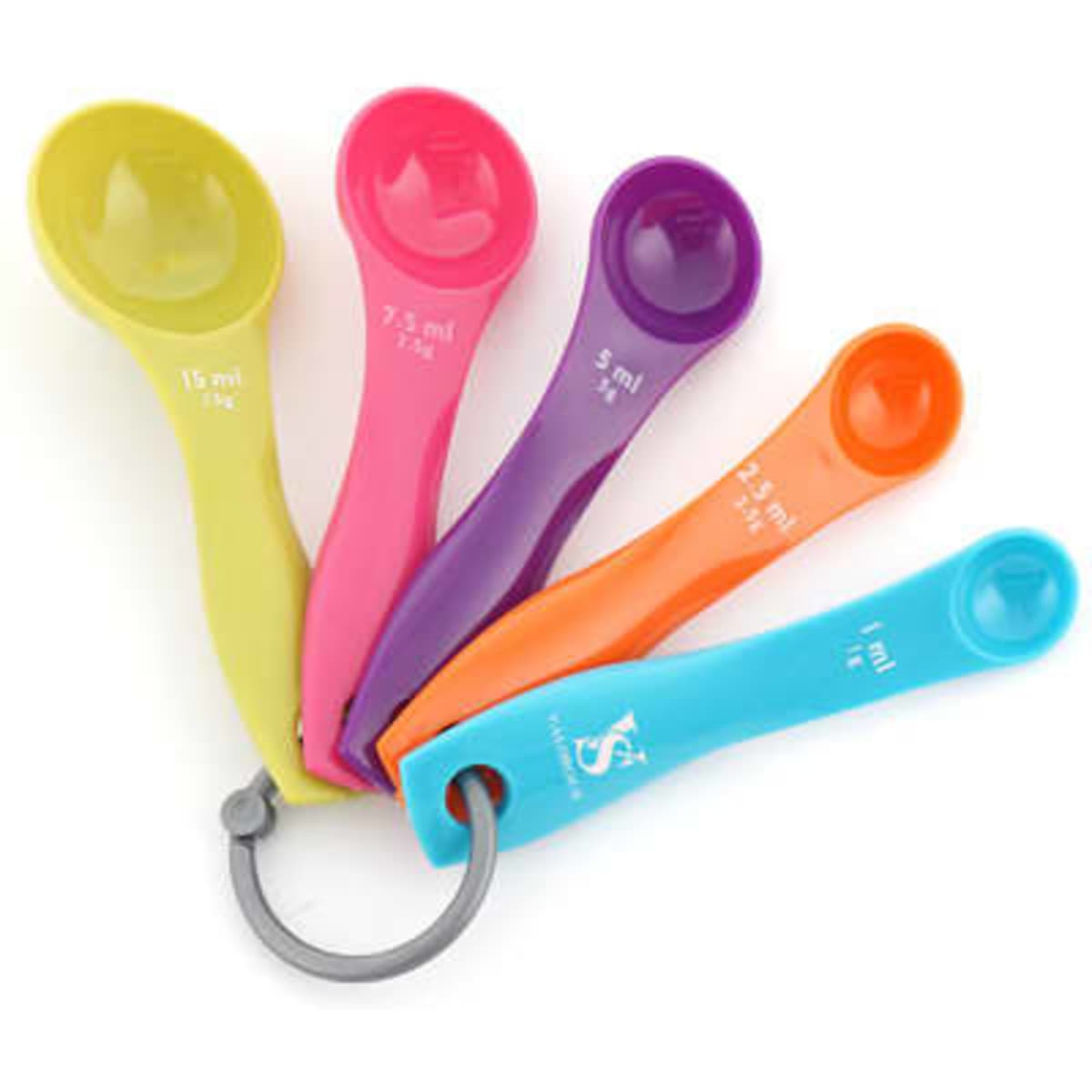 A set of five colourful plastic measuring spoons in green, pink, purple, orange, and blue, attached with a ring.