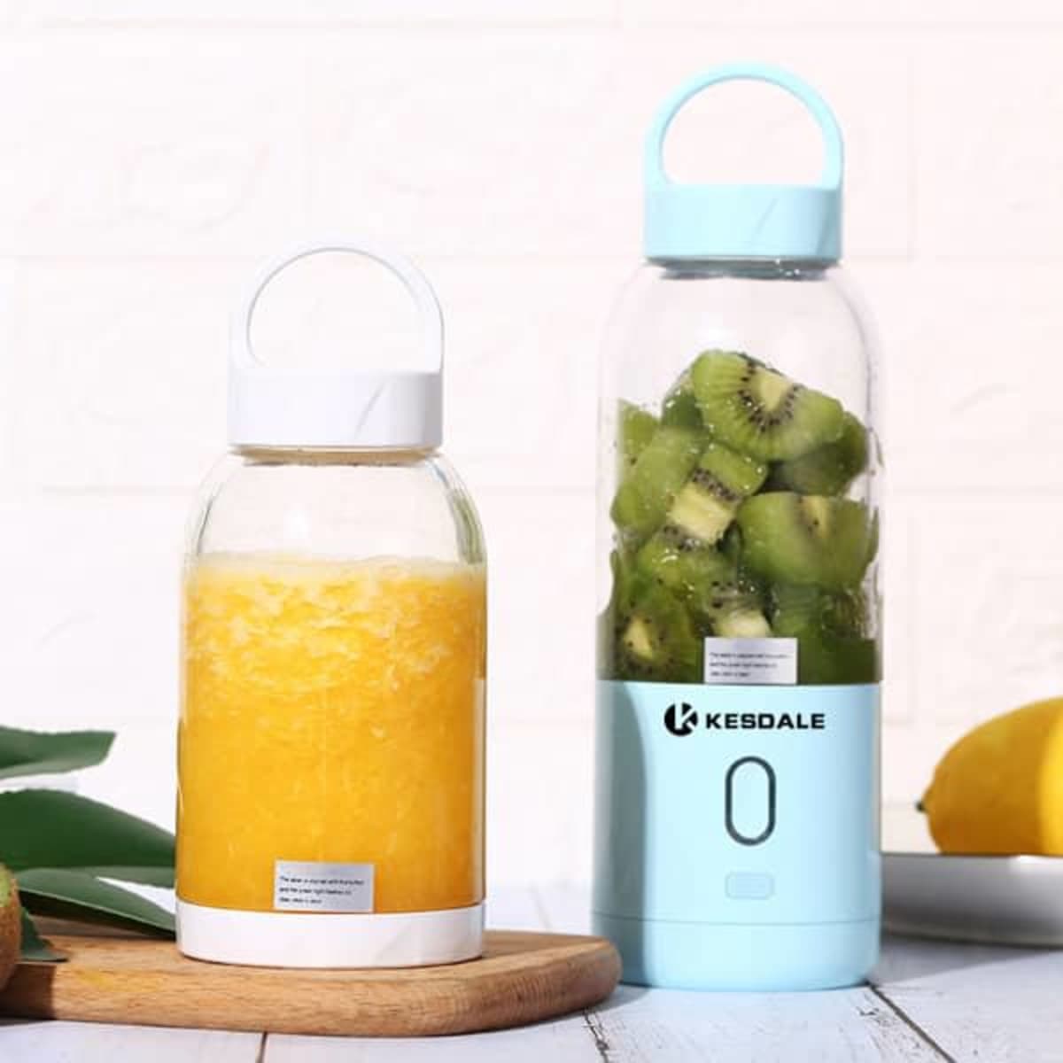 A drink bottle with a light blue lid and base, featuring a logo, alongside a clear bottle with orange beverage and green fruit.