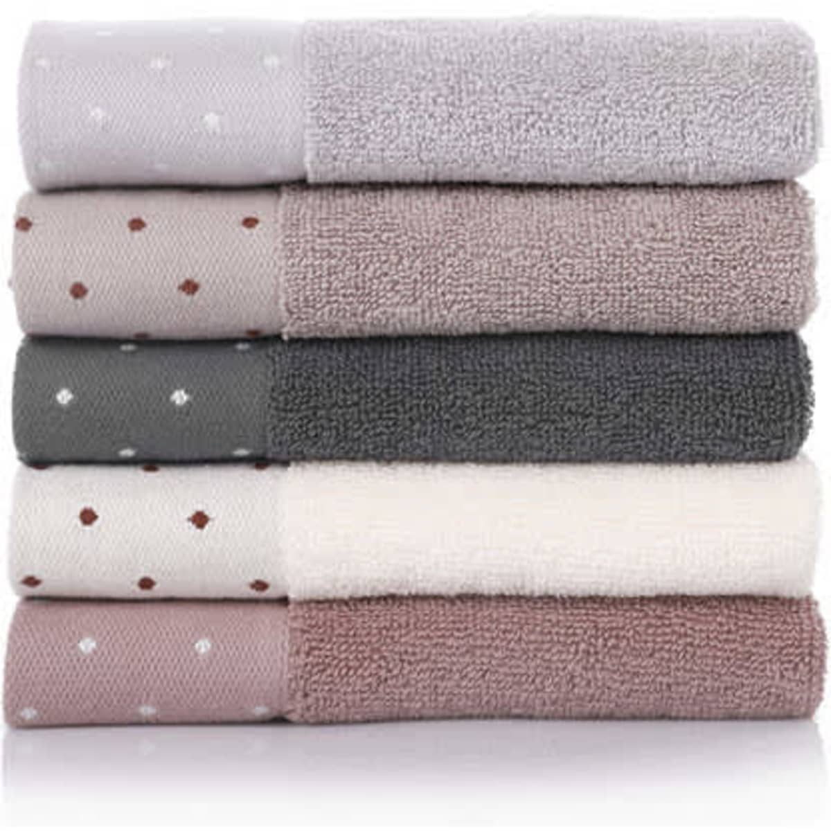 A stack of square cotton towels in shades of grey, pink, and cream, featuring varying textures and patterns.