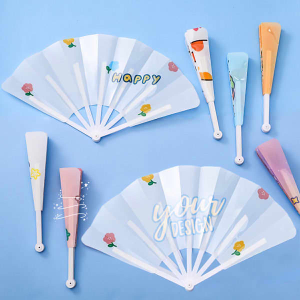 A selection of custom folding plastic hand fans in various pastel colours with different designs and a logo.