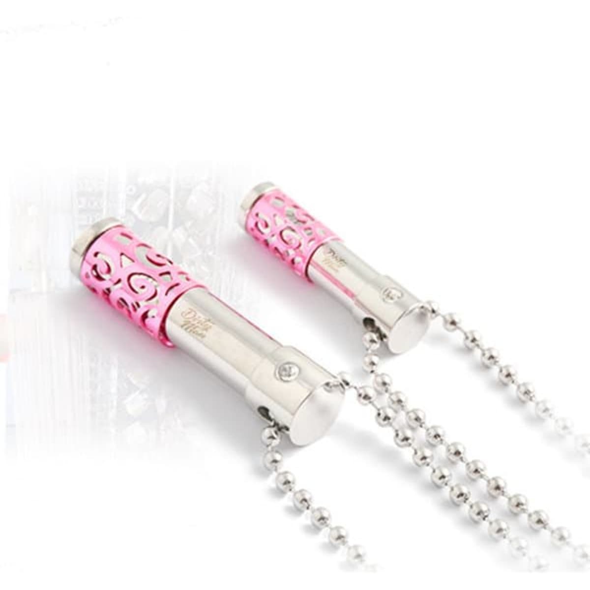 A pink and silver perfume bottle pendant necklace with intricate cut-out designs and a bead chain.