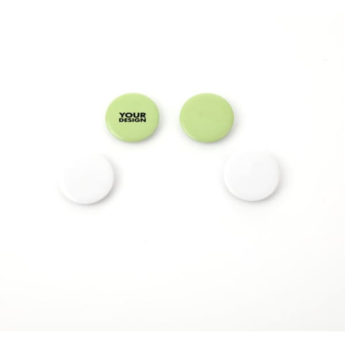 A set of four button badges, two in pale green and two in white, featuring a design placeholder.