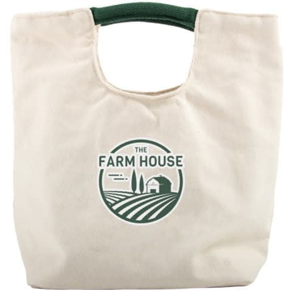 A portable canvas lunch bag in cream with a green handle and a logo featuring farming imagery.