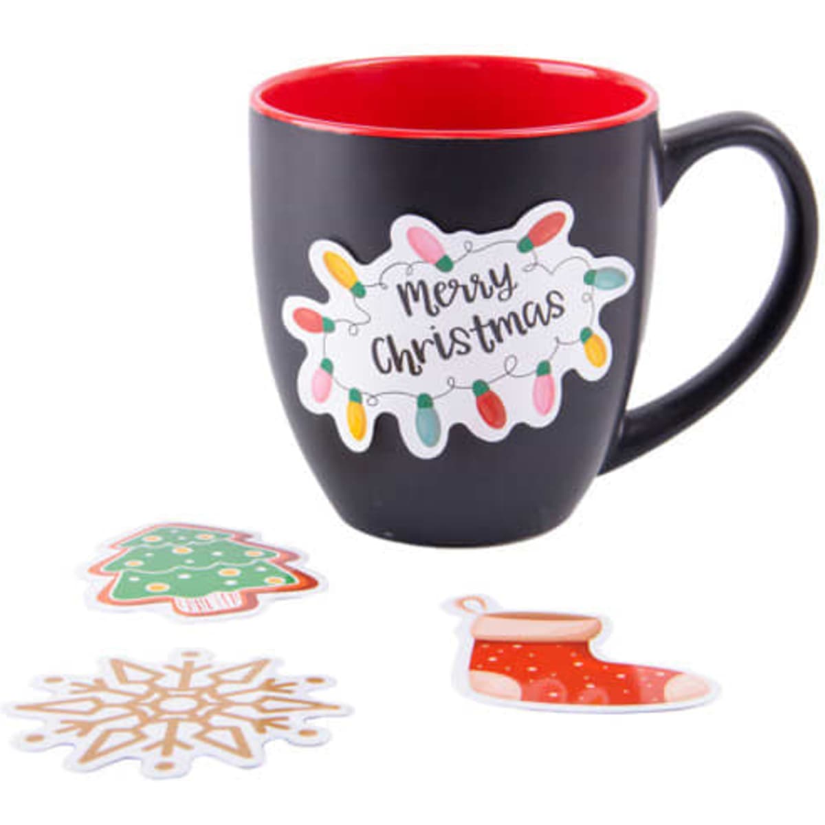 A black mug with a red interior features a festive sticker, alongside Christmas-themed stickers: a tree, snowflake, and stocking.