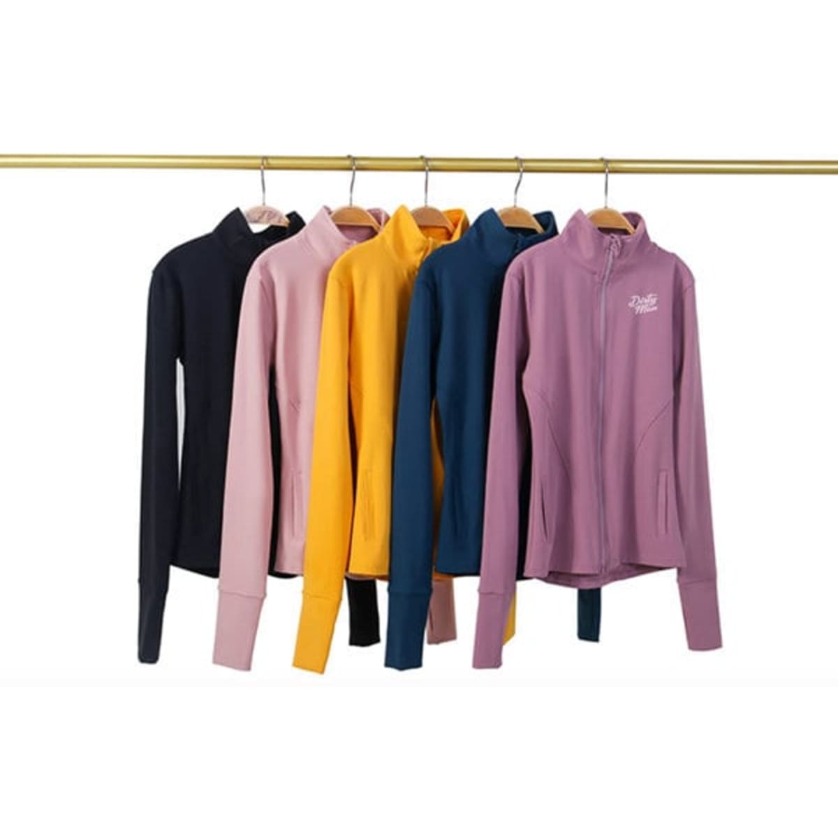 A collection of full zip yoga jackets in navy, pink, yellow, teal, and purple, hanging on a rack.