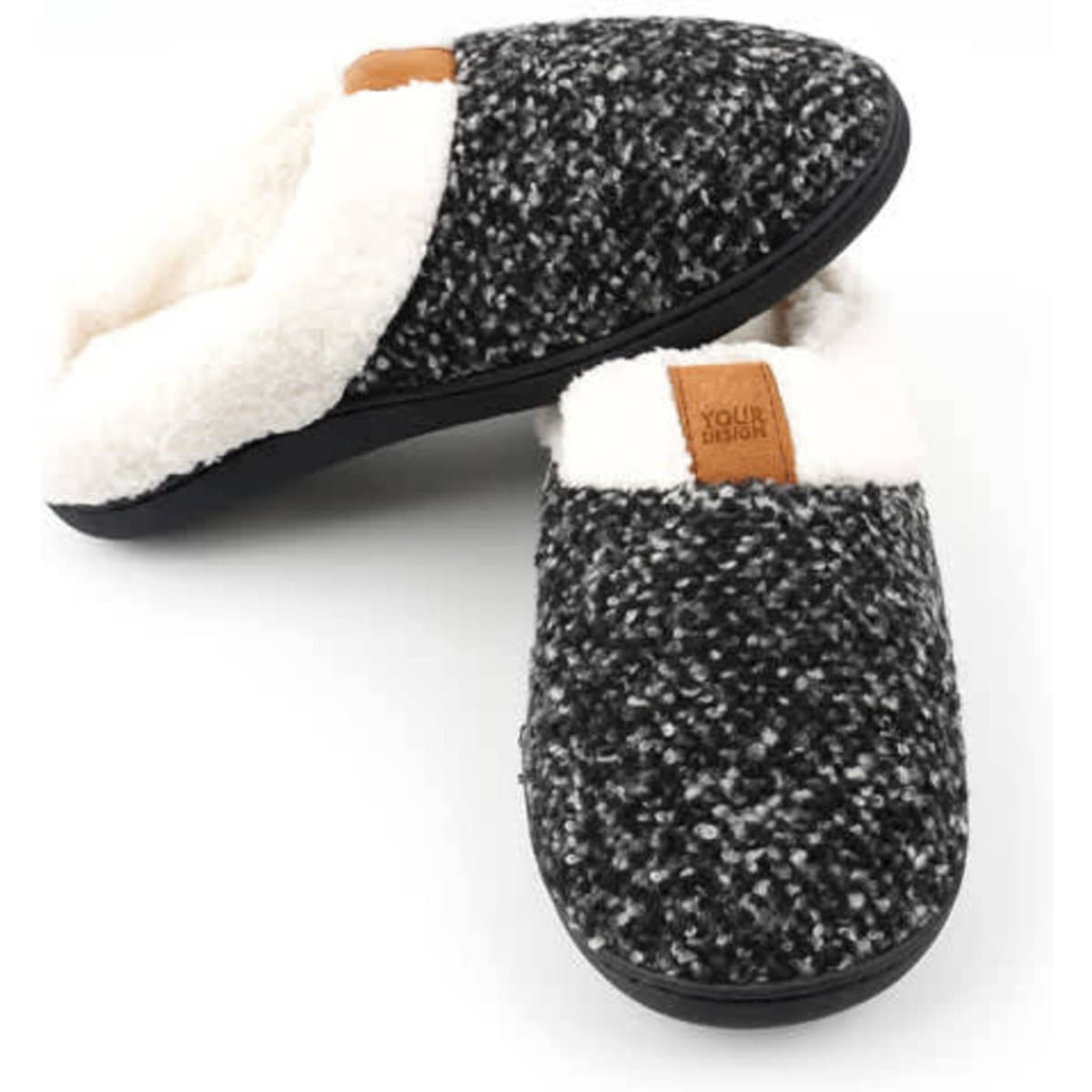Indoor fleece slippers in a black and white knit design with a soft, white lining and a branded label.