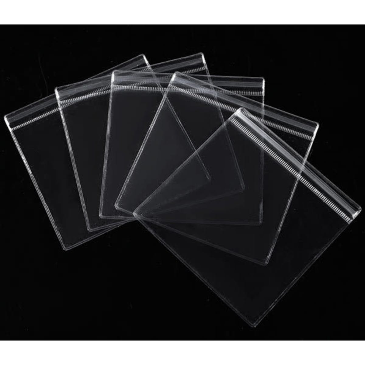 A set of clear plastic seal bags in various sizes, featuring a zip-lock closure and arranged on a black background.