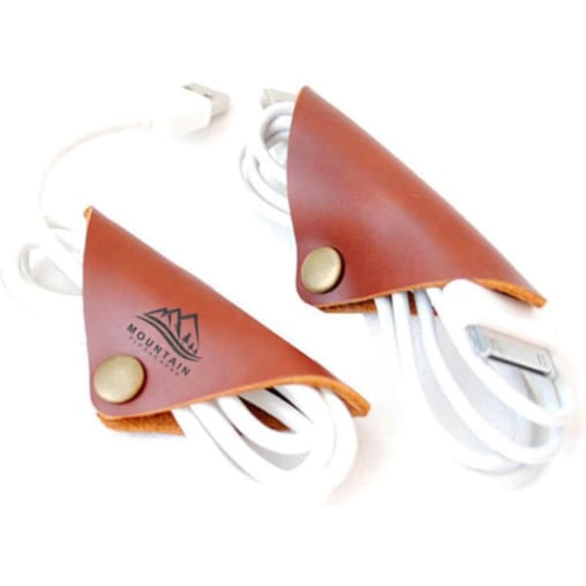 Two brown leather cable organisers with a logo, holding white charging cables neatly.