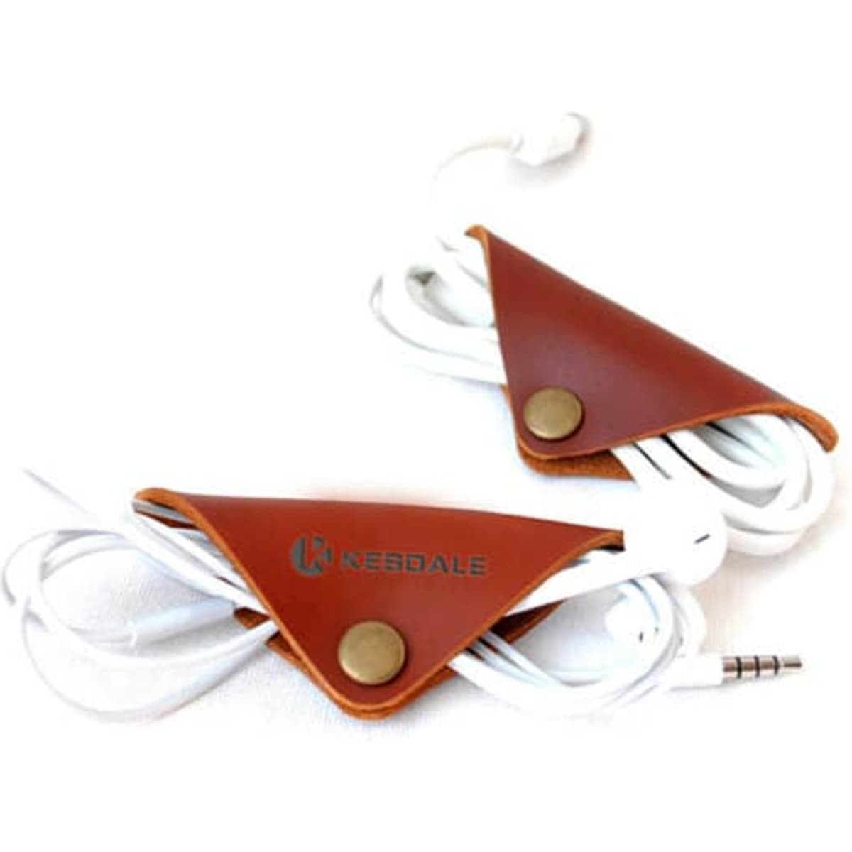 A leather cable organiser in a triangular shape, featuring a brown finish and holding white earphone cables.