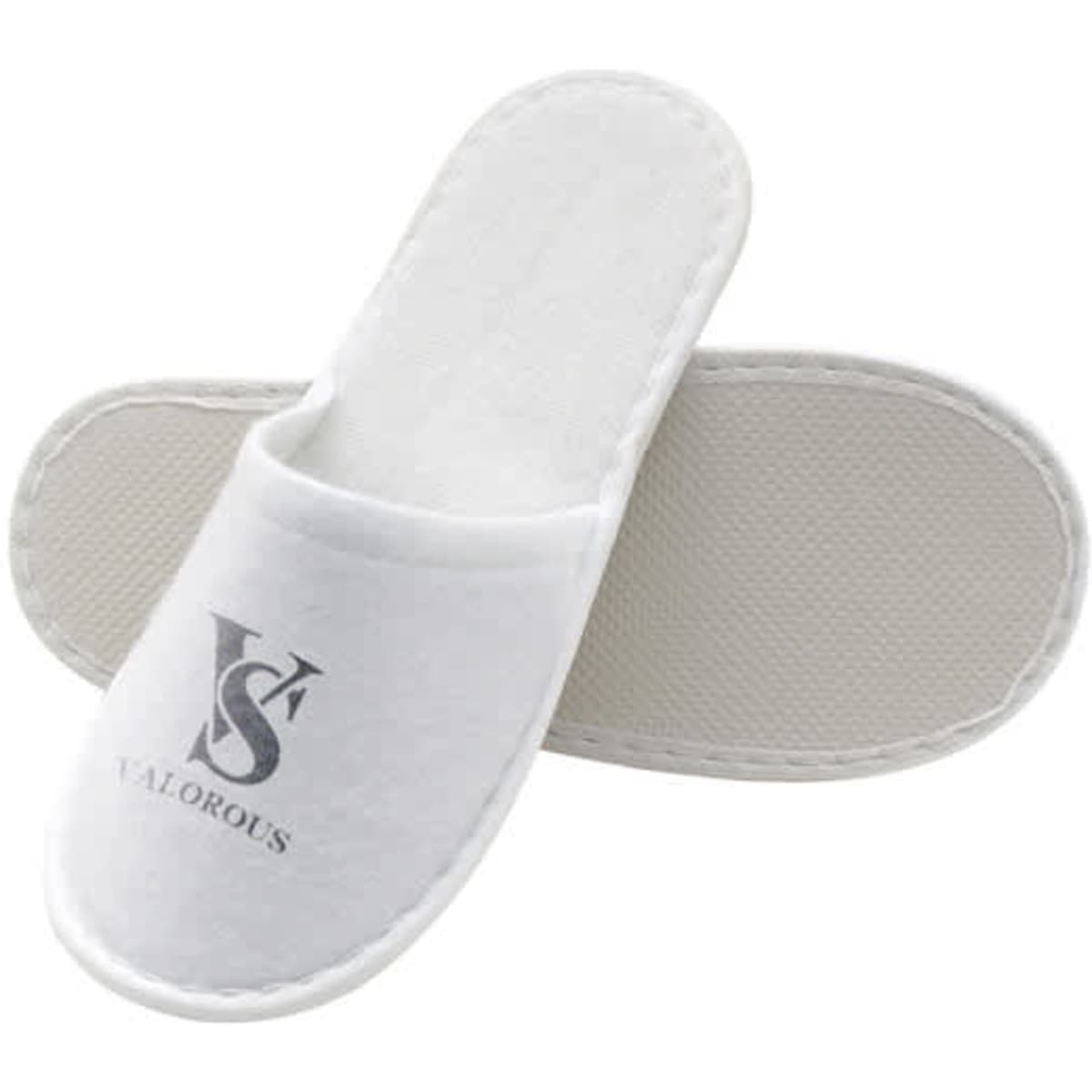 White disposable hotel slippers with a textured sole and a logo printed on the upper.