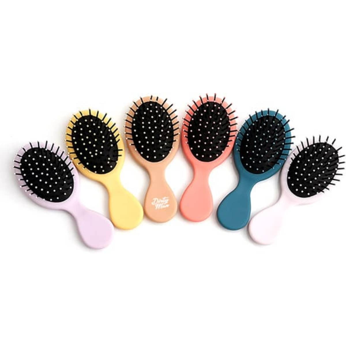 A set of seven children's air cushion combs in pastel colours, featuring soft bristles and oval shapes.