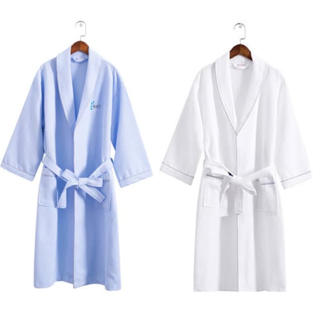 Two adult hotel bathrobes are displayed, one in light blue and the other in white, both featuring a logo.