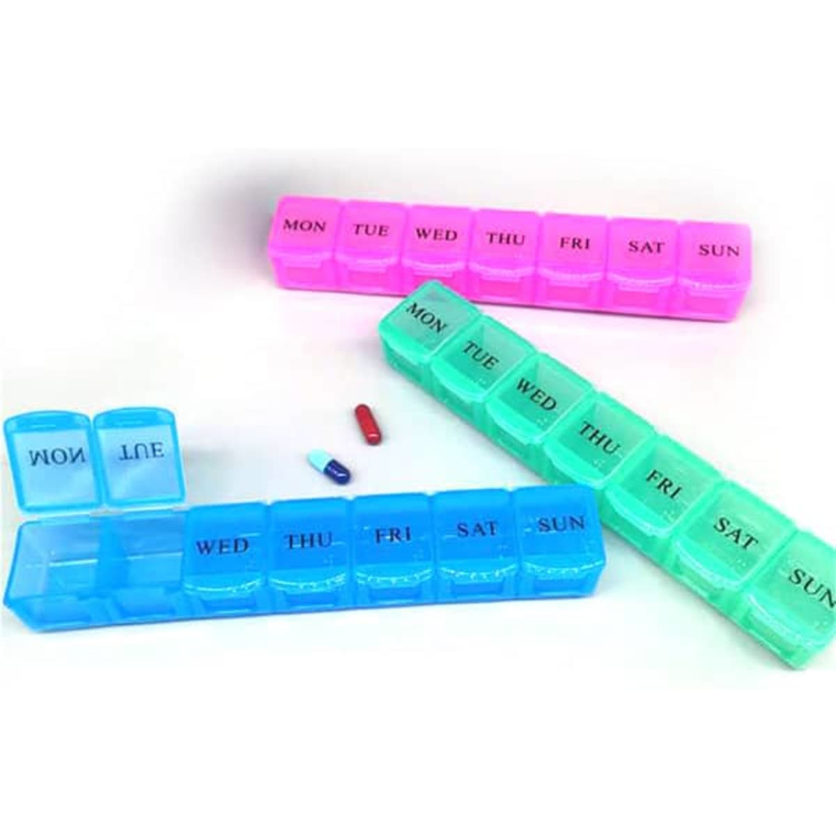 A 7-day pill dispenser with compartments in pink and green, featuring labels for each day of the week.