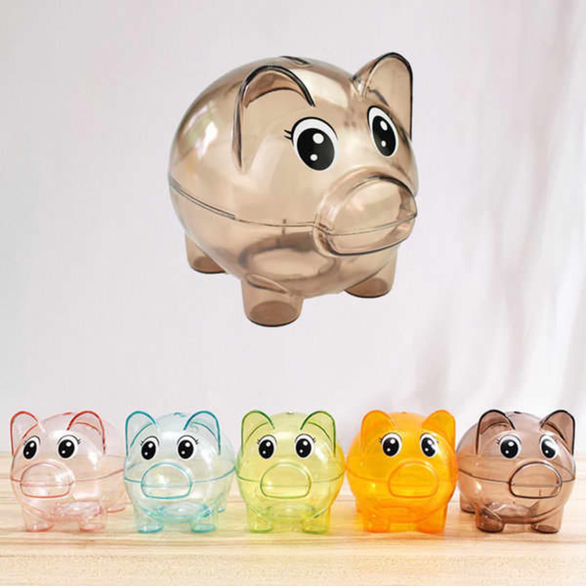Clear plastic piggy banks in various colours: blue, green, orange, and a translucent brown. Each features a cute face and a logo.