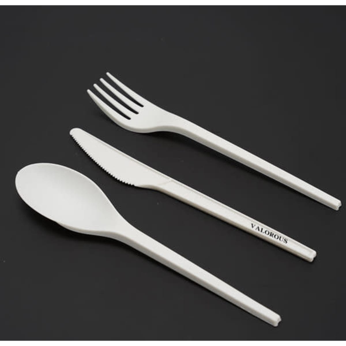 A 7-inch degradable cutlery set in white, including a spoon, fork, and knife. The set has a logo.