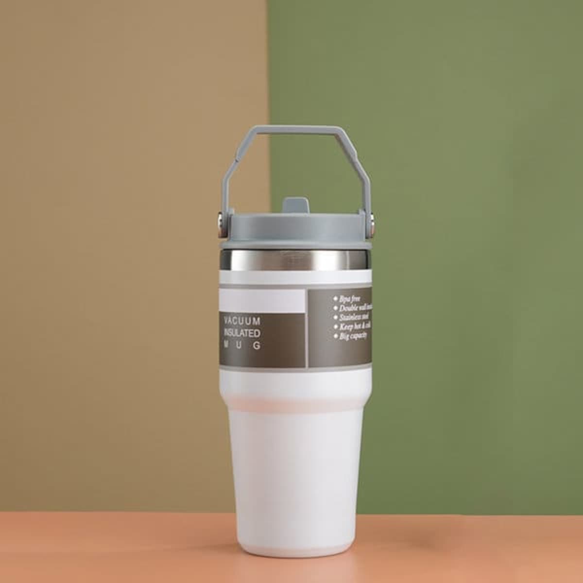 A drink bottle featuring a grey handle and a white body, designed as an insulated tumbler with a logo.