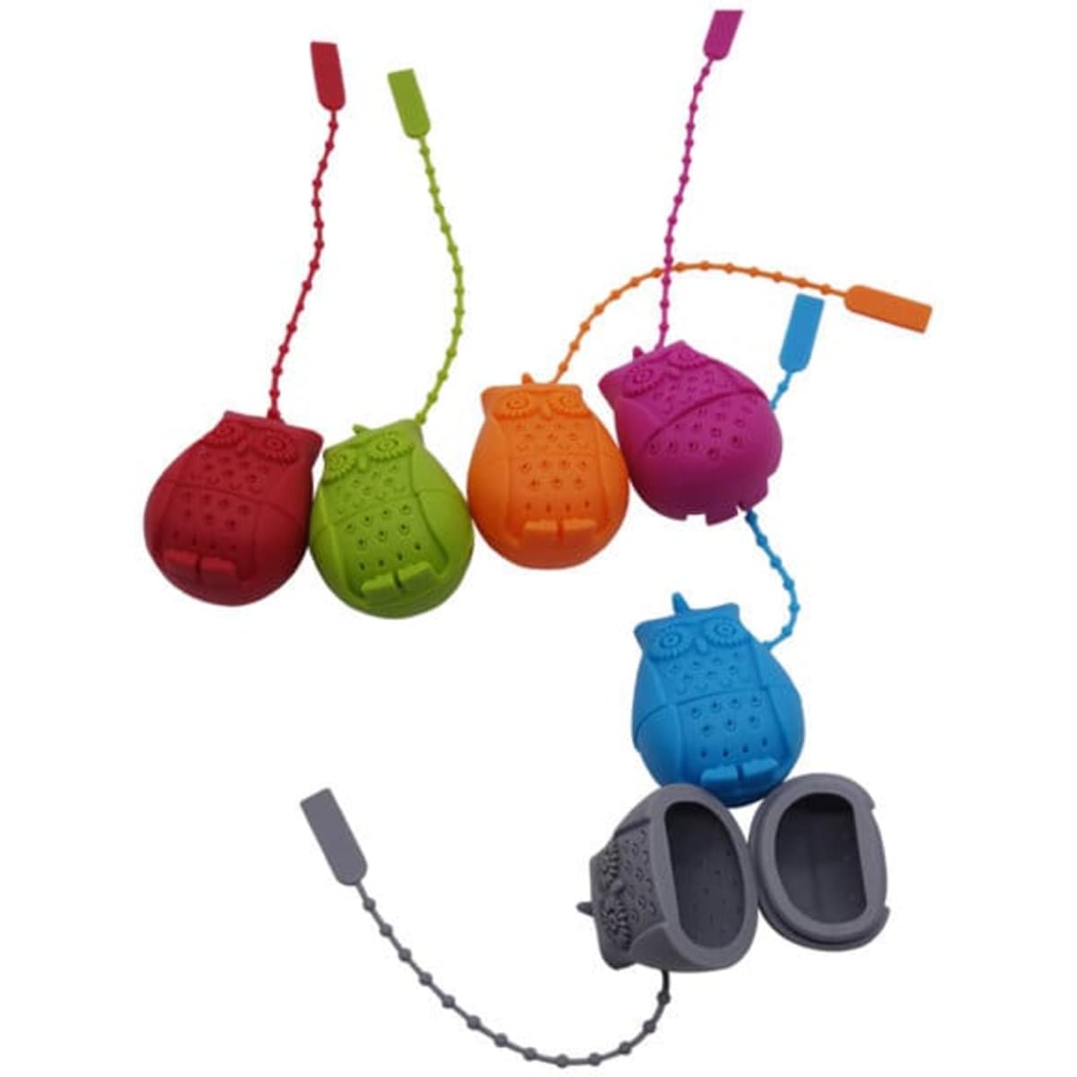 A set of colourful owl-shaped silicone tea infusers in red, green, purple, and blue. Each infuser has a chain for easy removal.