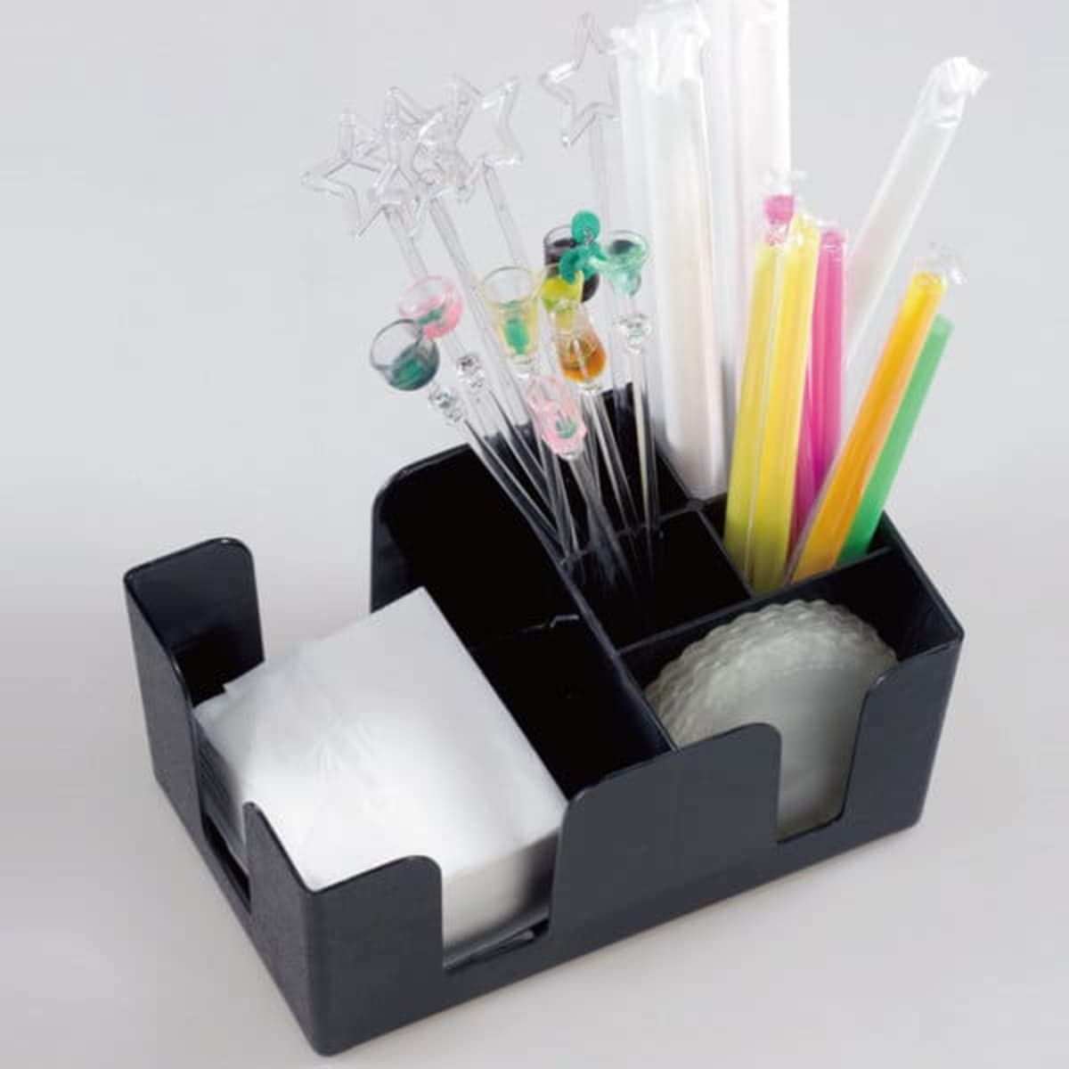 A multifunction black tissue straw case featuring assorted colourful drinking straws and compartments for napkins.