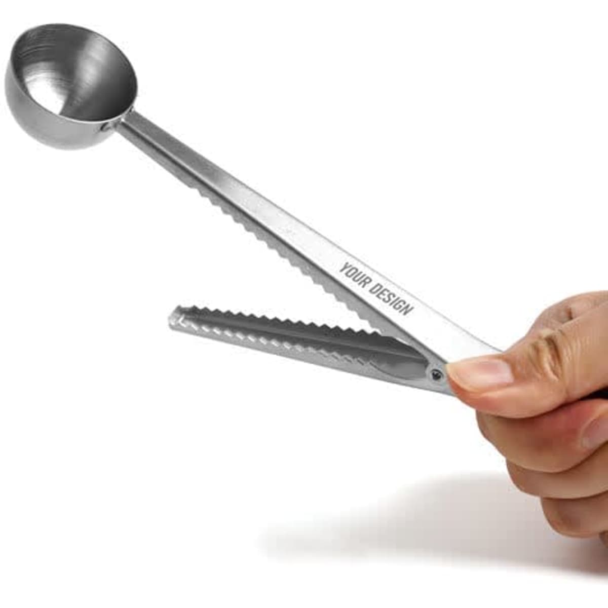 A stainless steel coffee spoon clip featuring a scoop and tongs design, held in a hand, with a branding logo visible.
