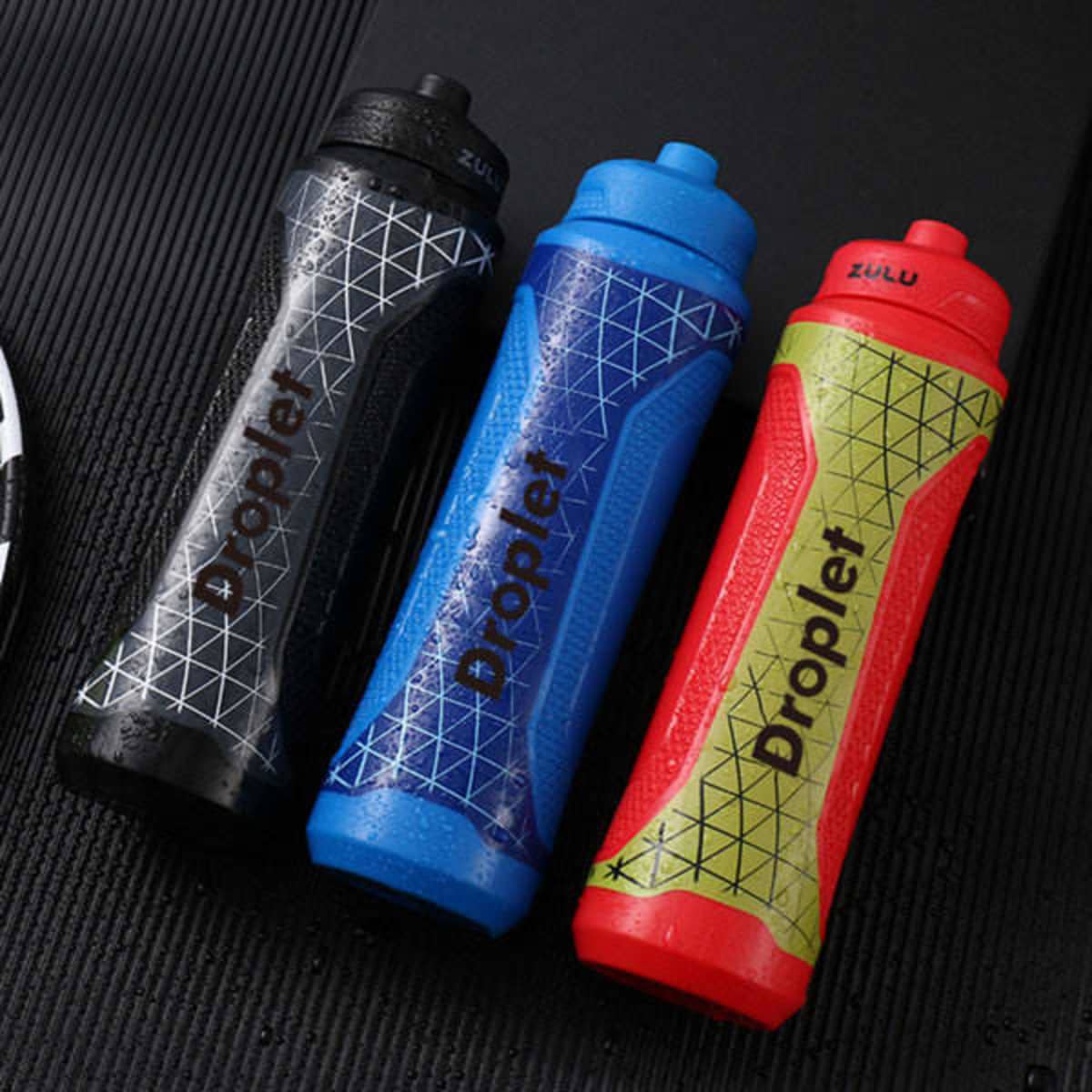A drink bottle set featuring three colours: black, blue, and red, each with a geometric design and a logo.