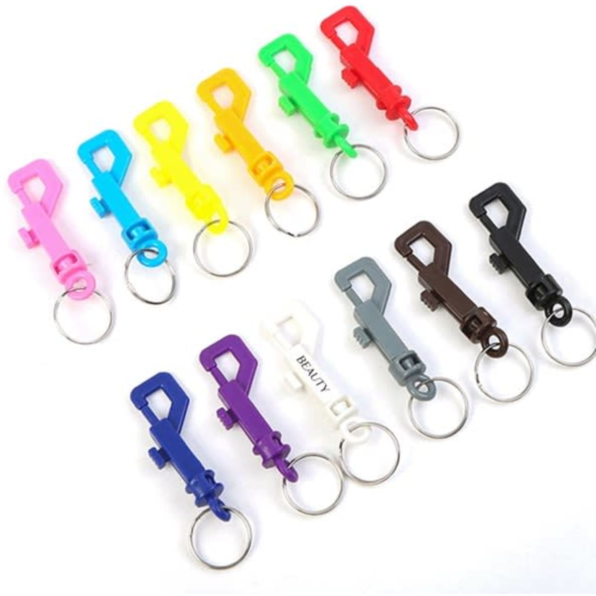 A variety of plastic snap hooks in multiple colours, each with a key ring attachment.