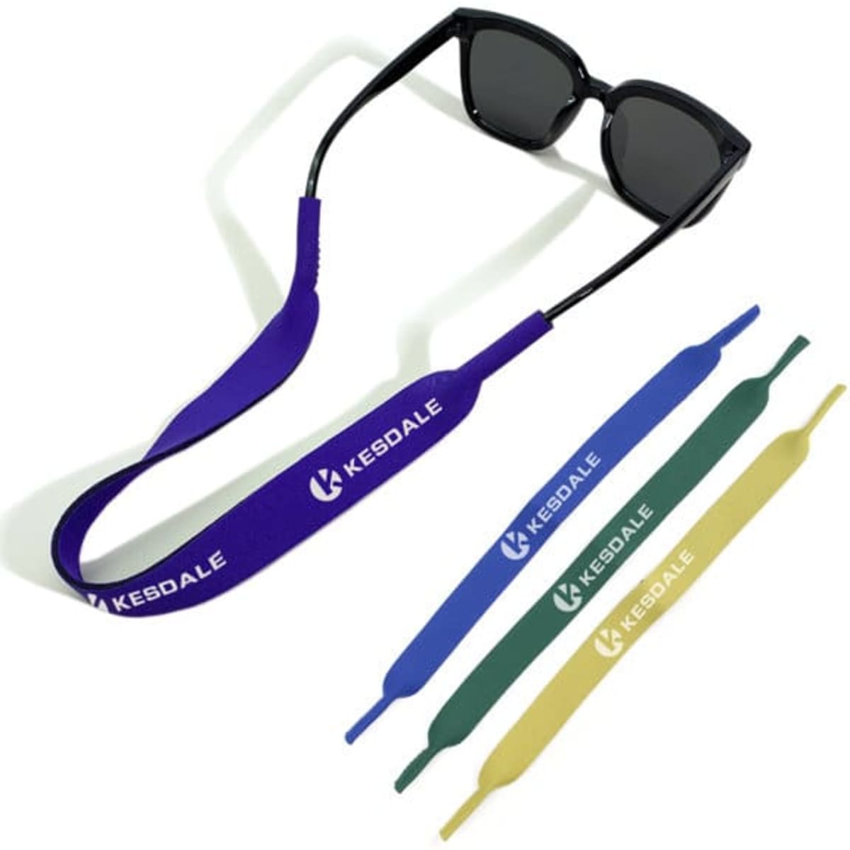 A pair of black sunglasses with a purple SBR elastic strap and additional straps in green, yellow, and blue.