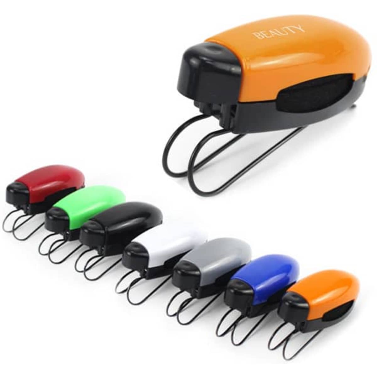 A set of staplers in various colours: red, green, white, black, grey, and orange, with one orange stapler in the foreground.