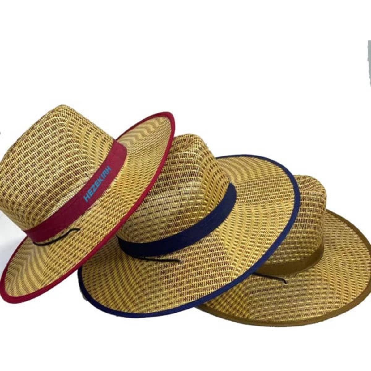 A wide brim cowboy straw hat in shades of beige with contrasting bands in red, navy, and olive green.