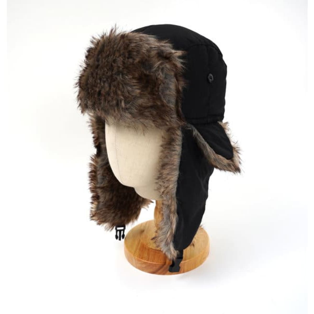 A black waterproof trapper hat with a faux fur trim, displayed on a mannequin head.