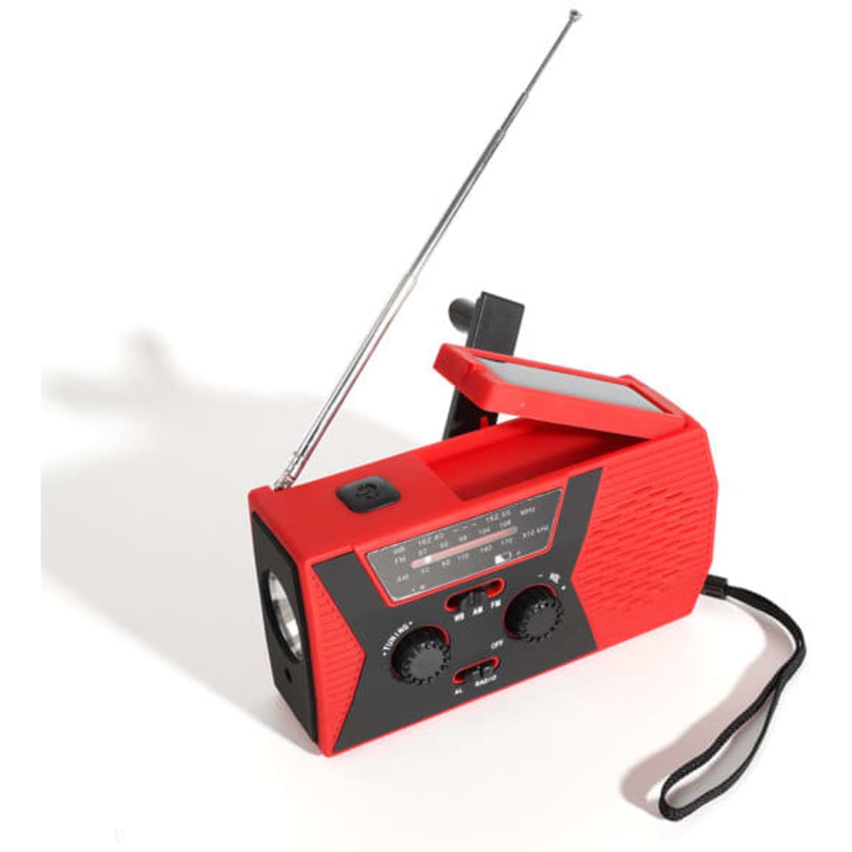 A red emergency solar hand crank portable radio with an extendable antenna and control dials. It features a strap for carrying.